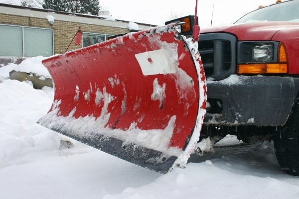 snow plow ensuring winter parking lot is safe