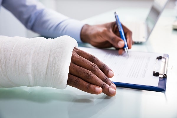 injured worker filling out workers' compensation form